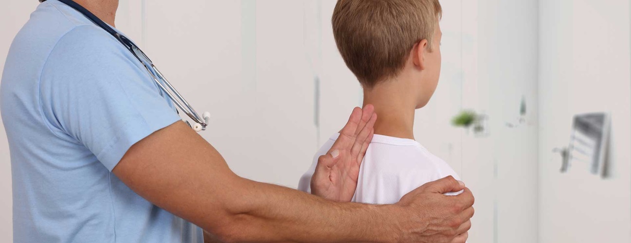 Doctor examining child's spine