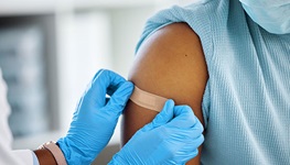 doctor puts band aid on arm