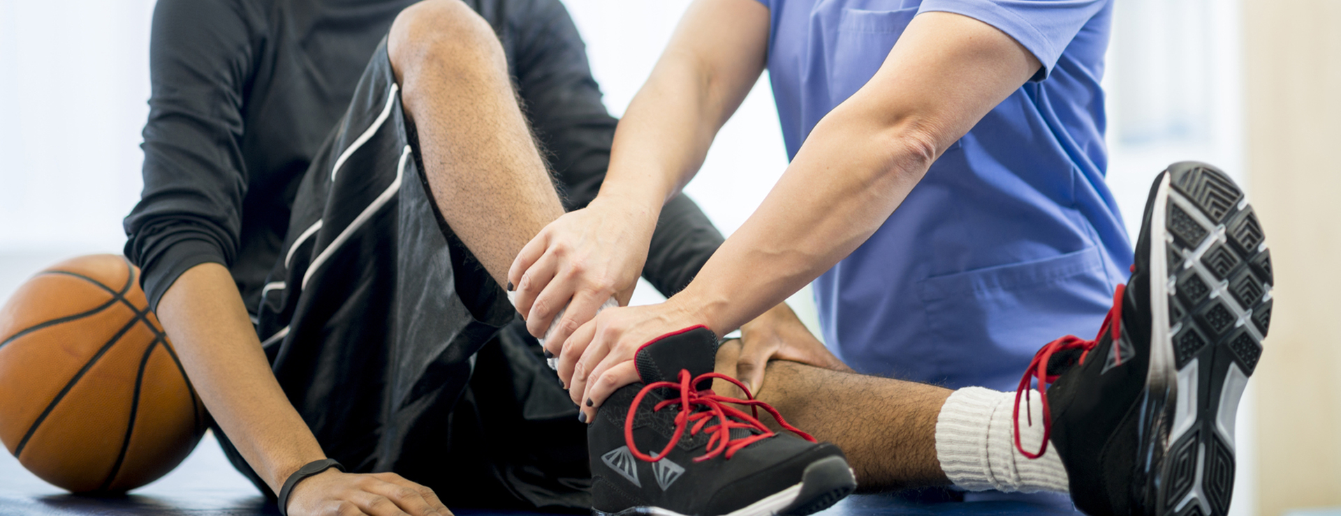 woman examining a man's ankle