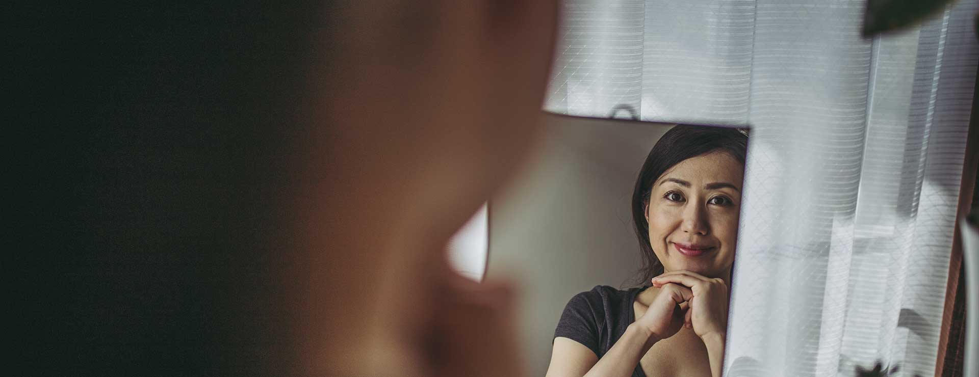 woman looking in mirror