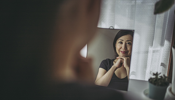 woman looking in mirror