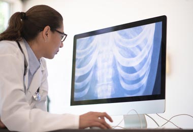 Radiologist examines abdominal x-ray