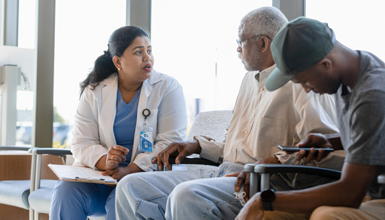 Nurse in waiting room speaking to patient and his family
