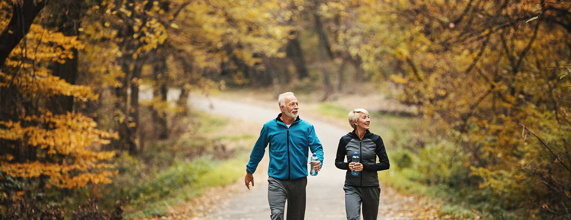 senior couple walking in woods