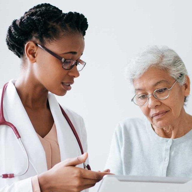 A doctor discusses a mammogram with a patient.