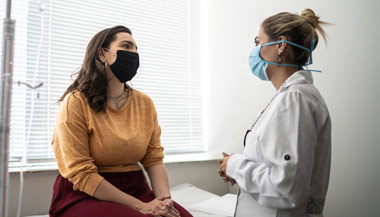 Patient and doctor discussing treatment in doctors office