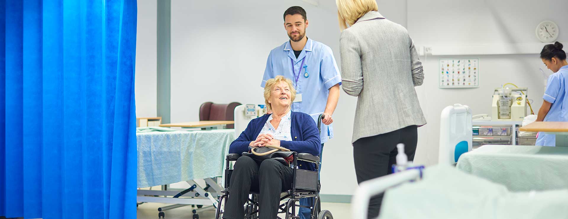 woman in wheelchair leaving hospital