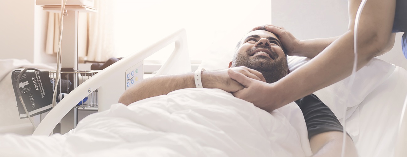 living organ donation - nurse comforting man in hospital bed