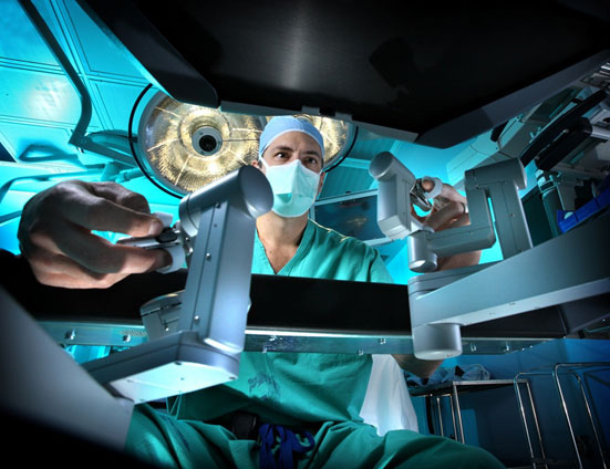 Dr. Pavlovich operating the robotic console in the operating room