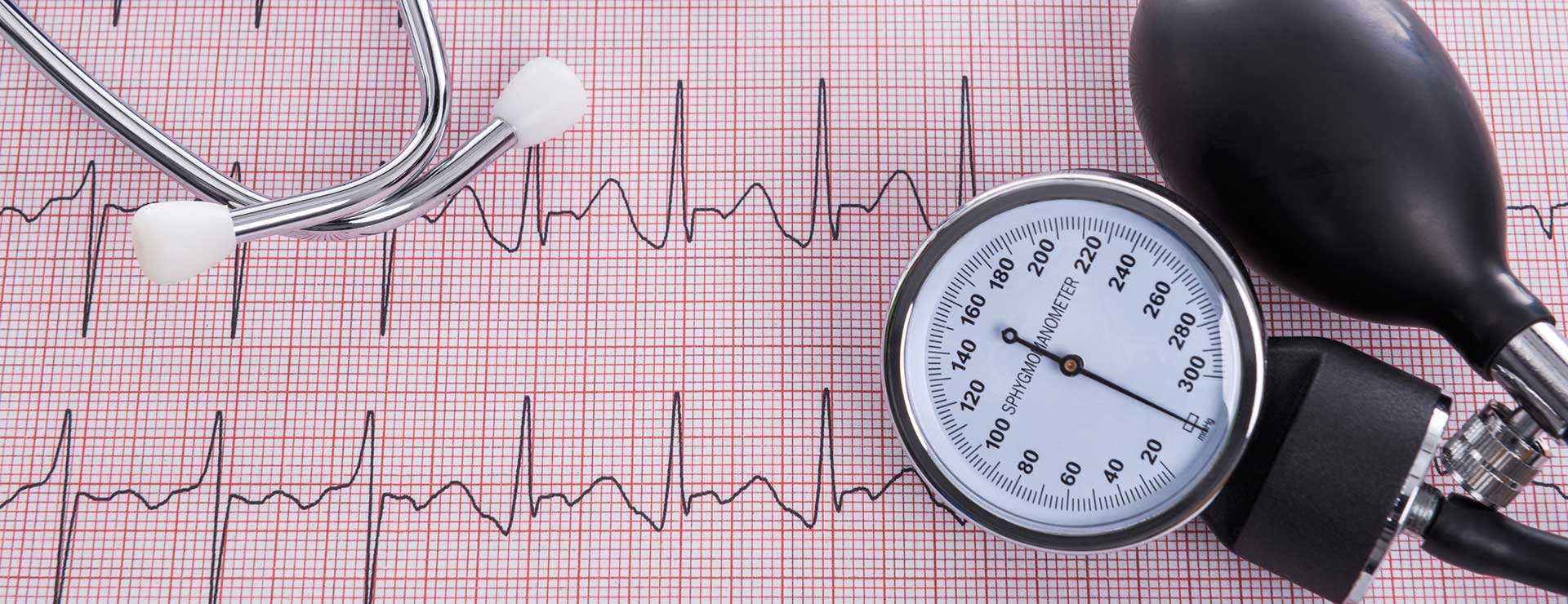 blood pressure measuring device on top of the ECG printout