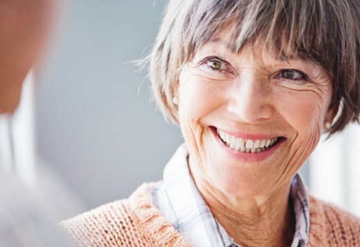 A senior woman smiling at the camera