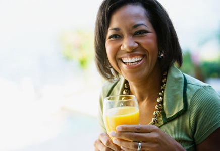 woman with a glass of orange juice