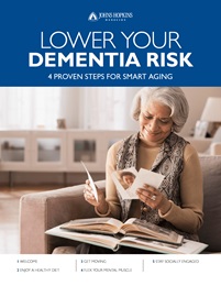The cover of the downloadable guide to lower Dementia risks, featuring a senior woman smiling as she looks through family photographs.