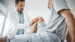 man having knee examined