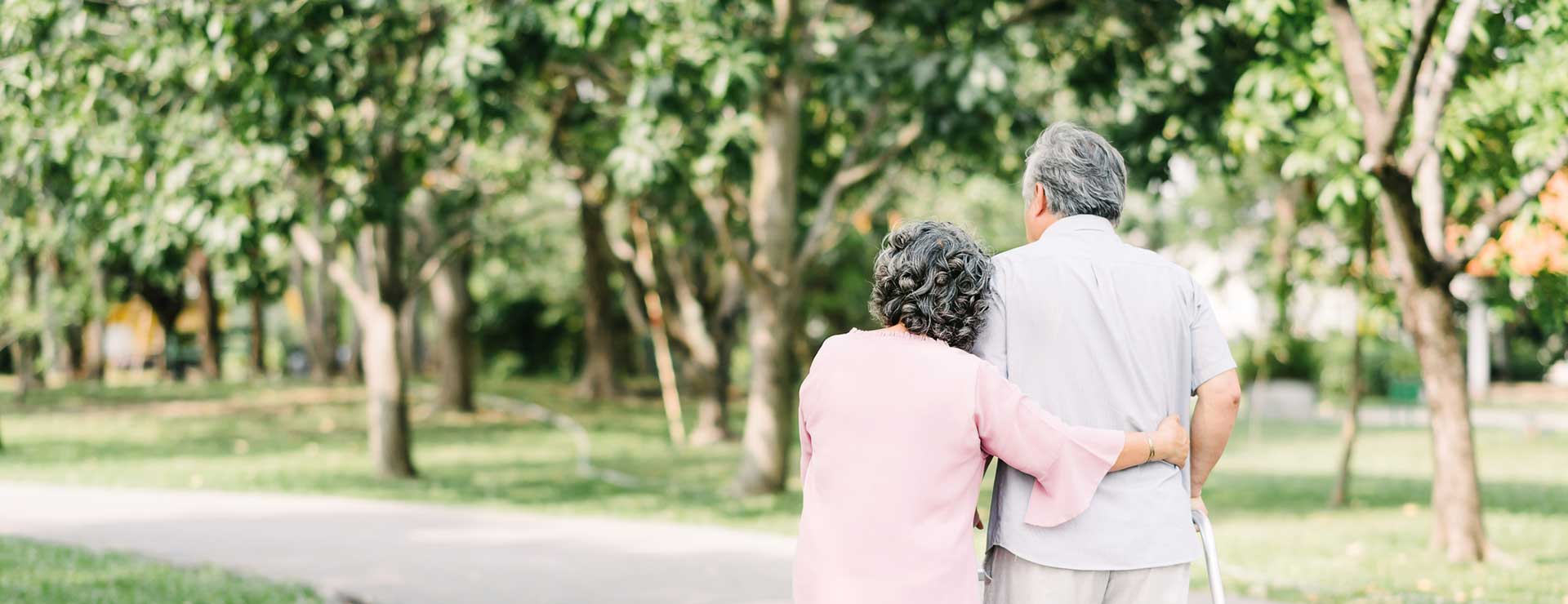 A senior couple walking in the park