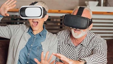 Two seniors wearing virtual reality goggles
