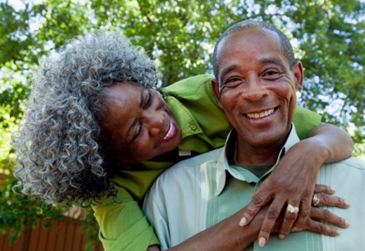 older african-american couple arms around each other