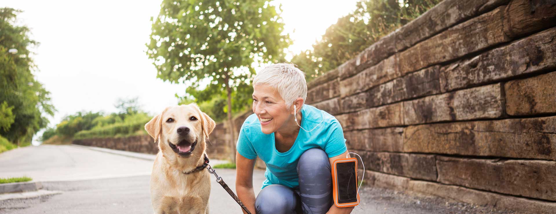 A woman taking a break from running with the dog