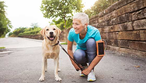 Woman and dog running in the park