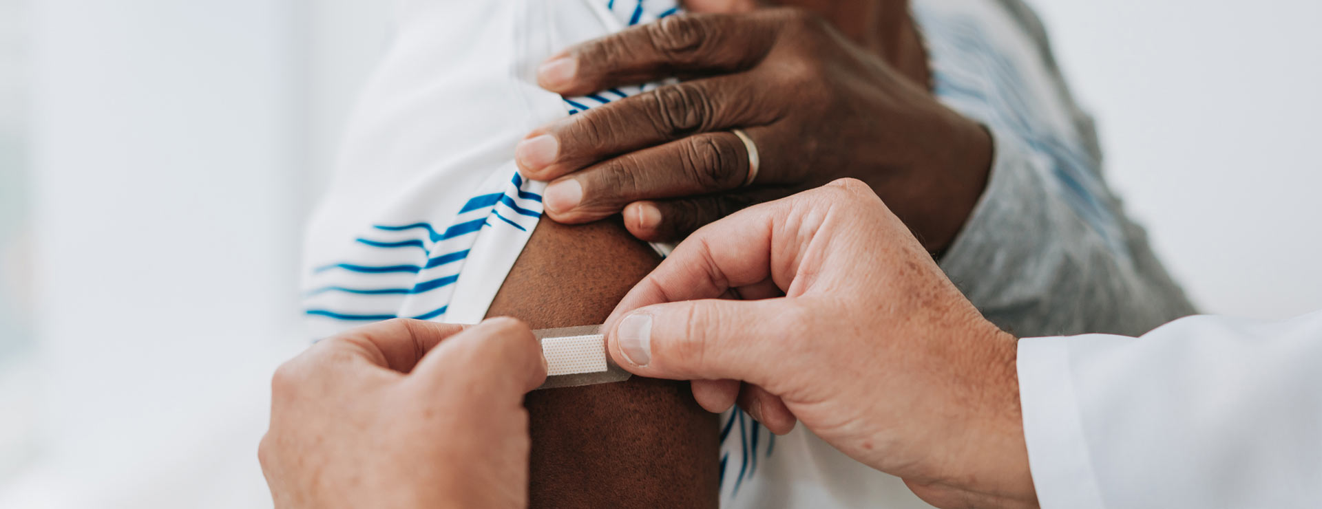 Woman getting a bandage on her new vaccine wound