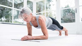 A woman in a plank position on the floor