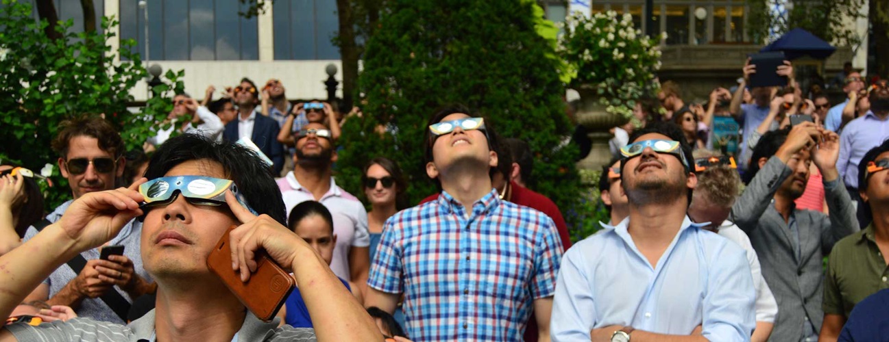 A group of people watching solar eclipse
