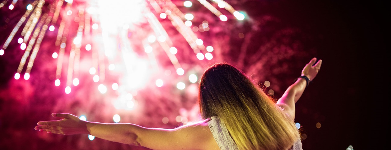 A young girl watching a fireworks display