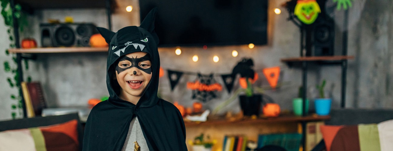 A young child celebrates Halloween dressed in costume