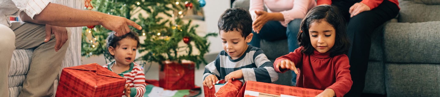 A family on Christmas morning opening presents