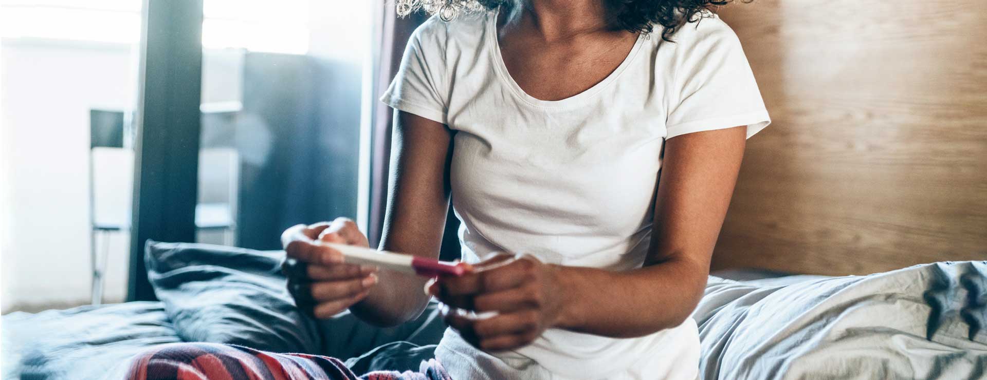 Women reading pregnancy test