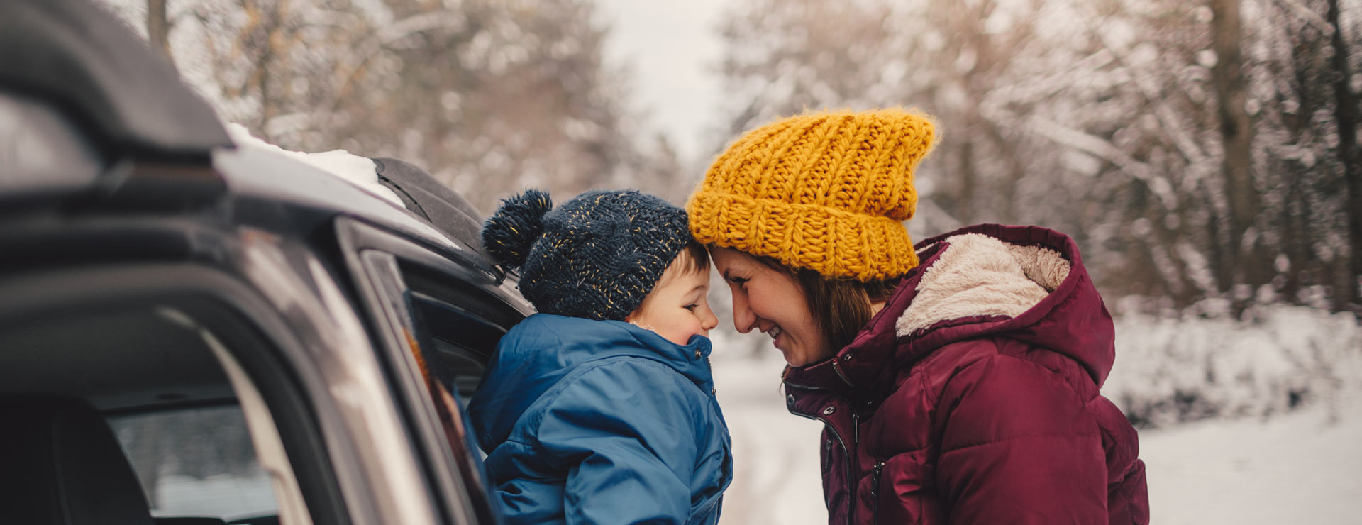Mother and child preparing for a trip in the snow