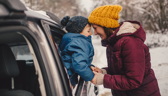 Mother and child preparing for a trip in the snow