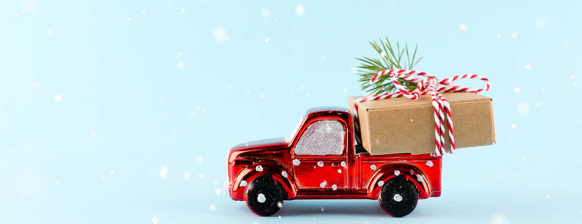 A toy truck with a small gift in the truck bed.
