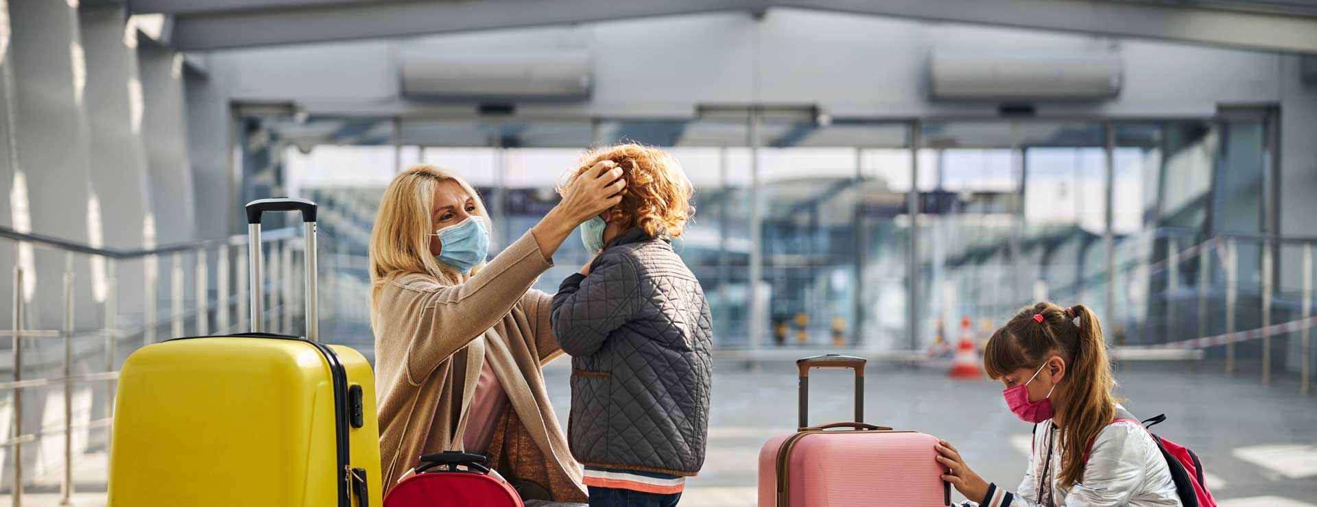 A mother prepares her two children to board a flight.