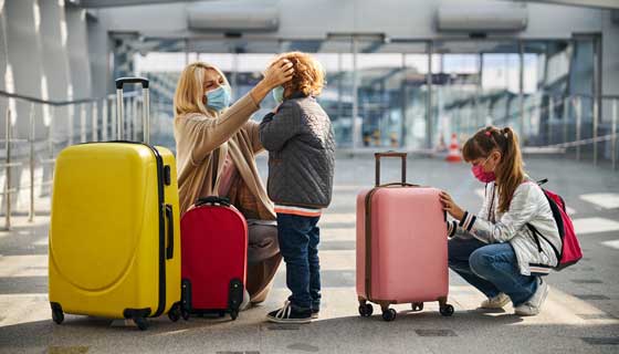 A mother prepares her two children to board a flight.