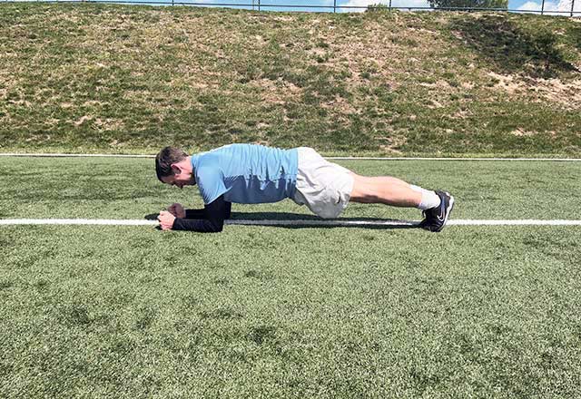 Image of John holding a plank position.