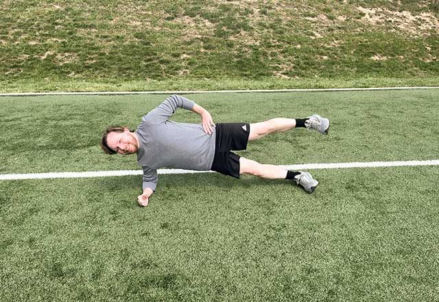 Image of Jimmy performing a side plank with leg lift.
