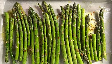 Rosemary asparagus on a baking sheet