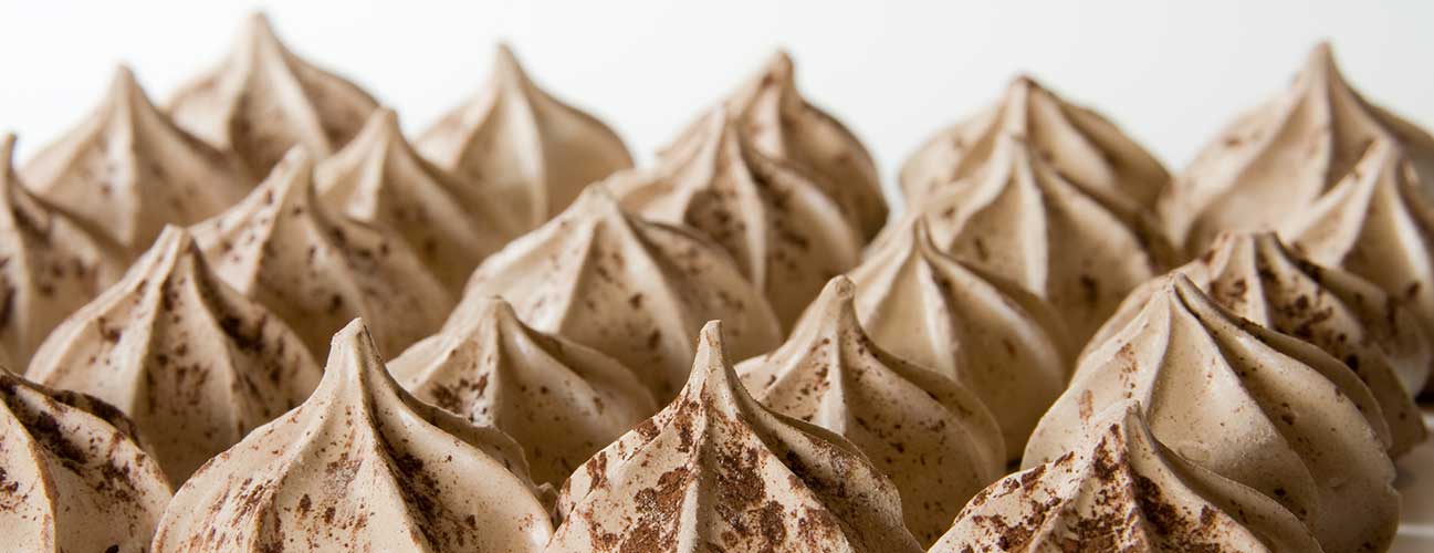 Star shaped meringue cookies dusted in cocoa powder