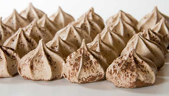 Star shaped meringue cookies dusted in cocoa powder