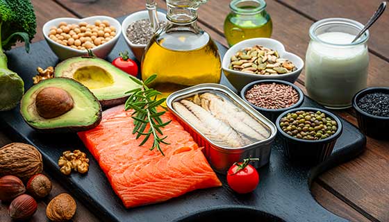 Spread of foods rich in healthy fats, including salmon, canned fish, nuts and avocados