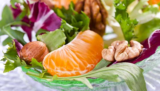 Orange slices and walnuts tossed in a salad