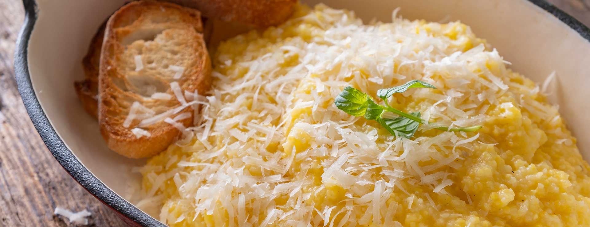A plate of polenta topped with cheese.