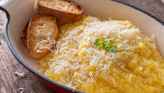 A plate of polenta topped with cheese.