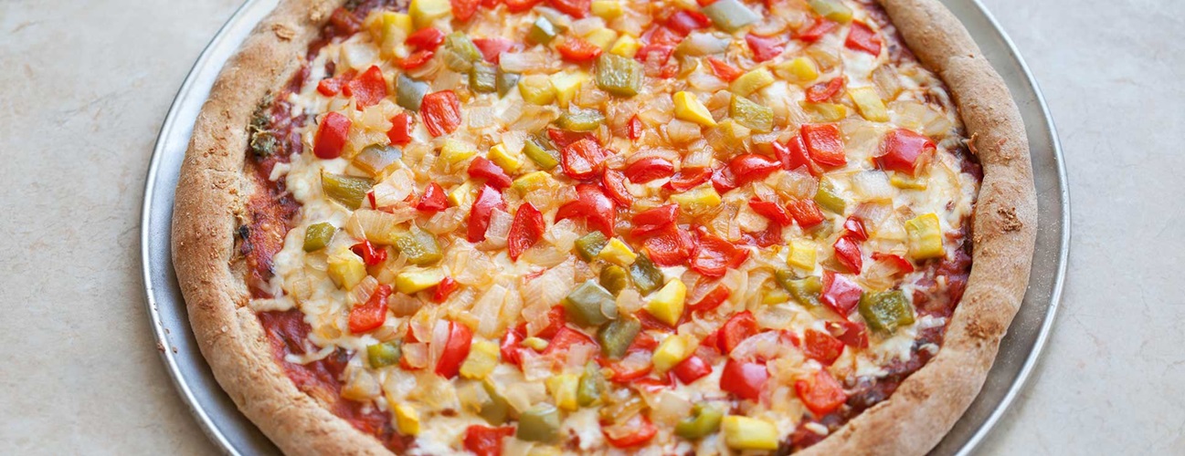pizza on wheat crust with peppers and onions
