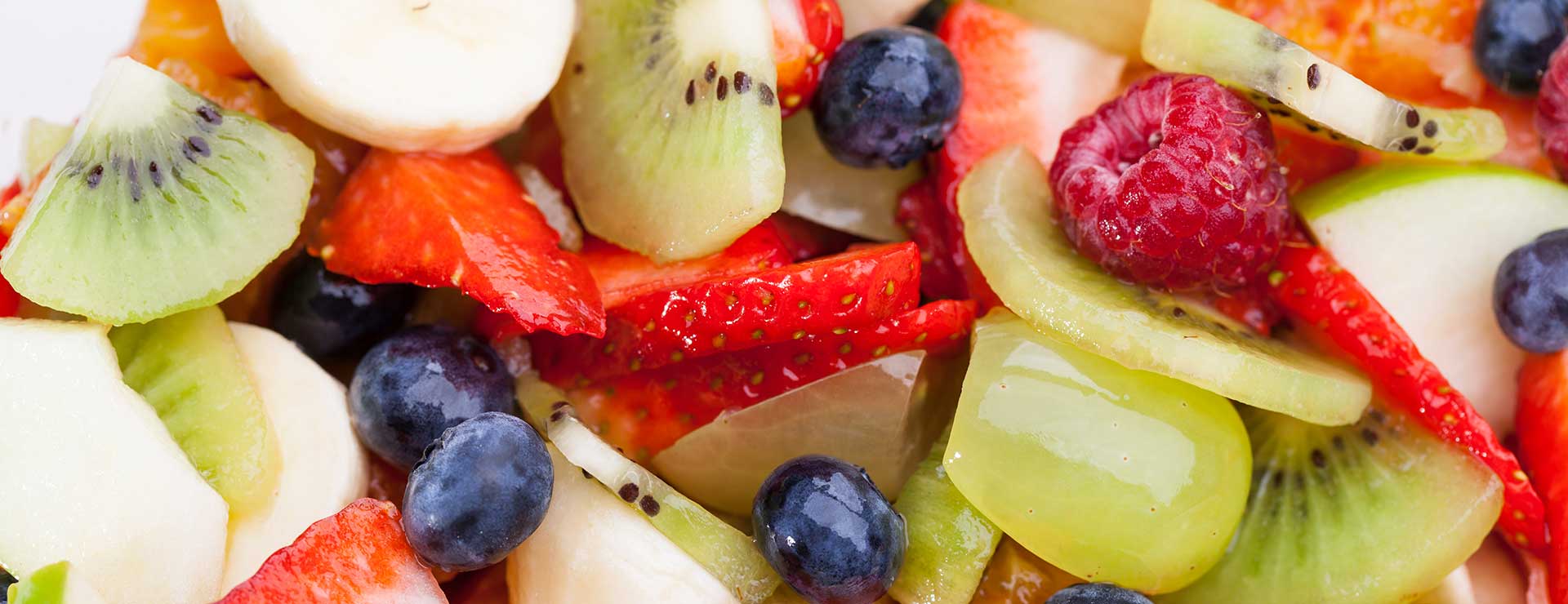 A close up of assorted cut fruits.