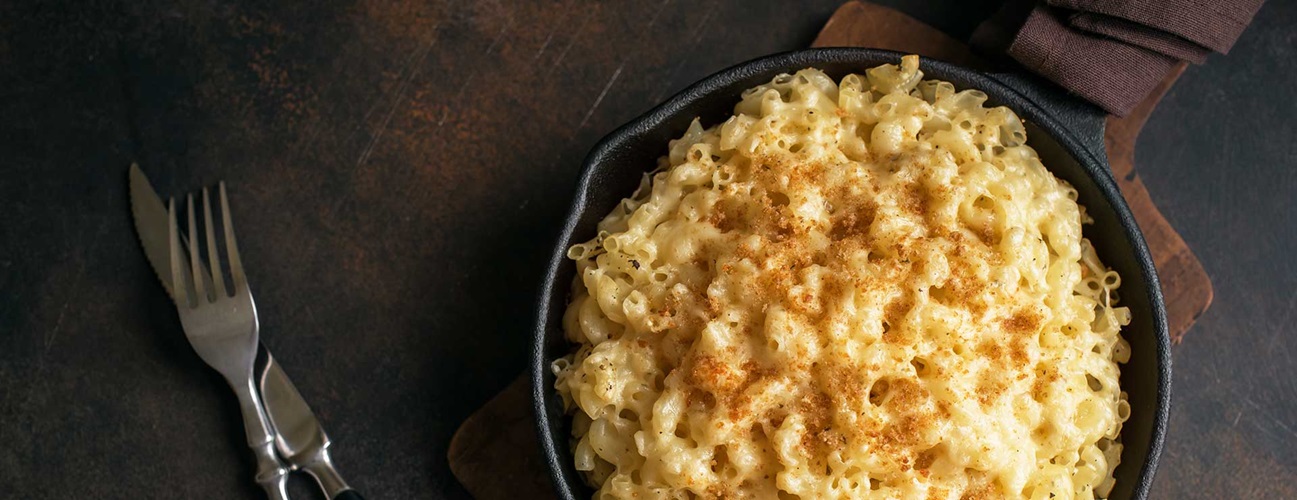 A large skillet of macaroni and cheese.