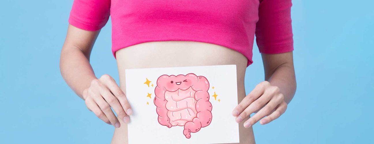 A woman holding a picture of a stomach and intestine
