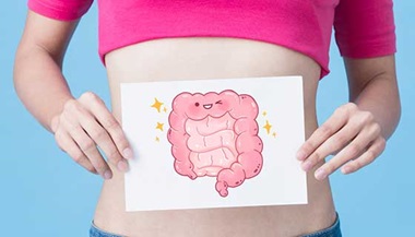 Woman holding a picture of a drawn intestine