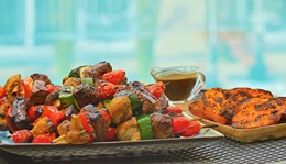 a plate of balsamic steak skewers with mixed vegetables
